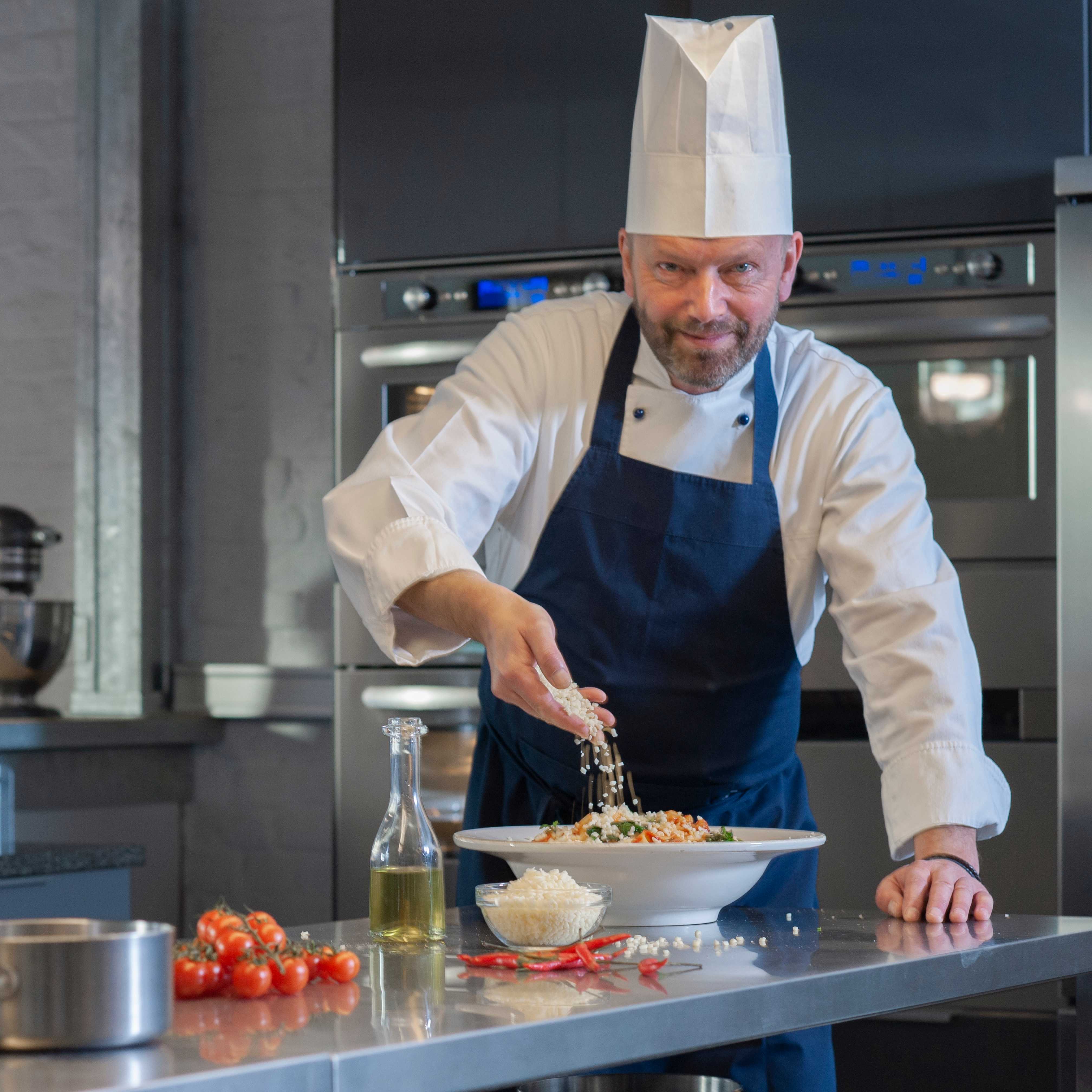 A chef is cooking in his kitchen, using mozzarella