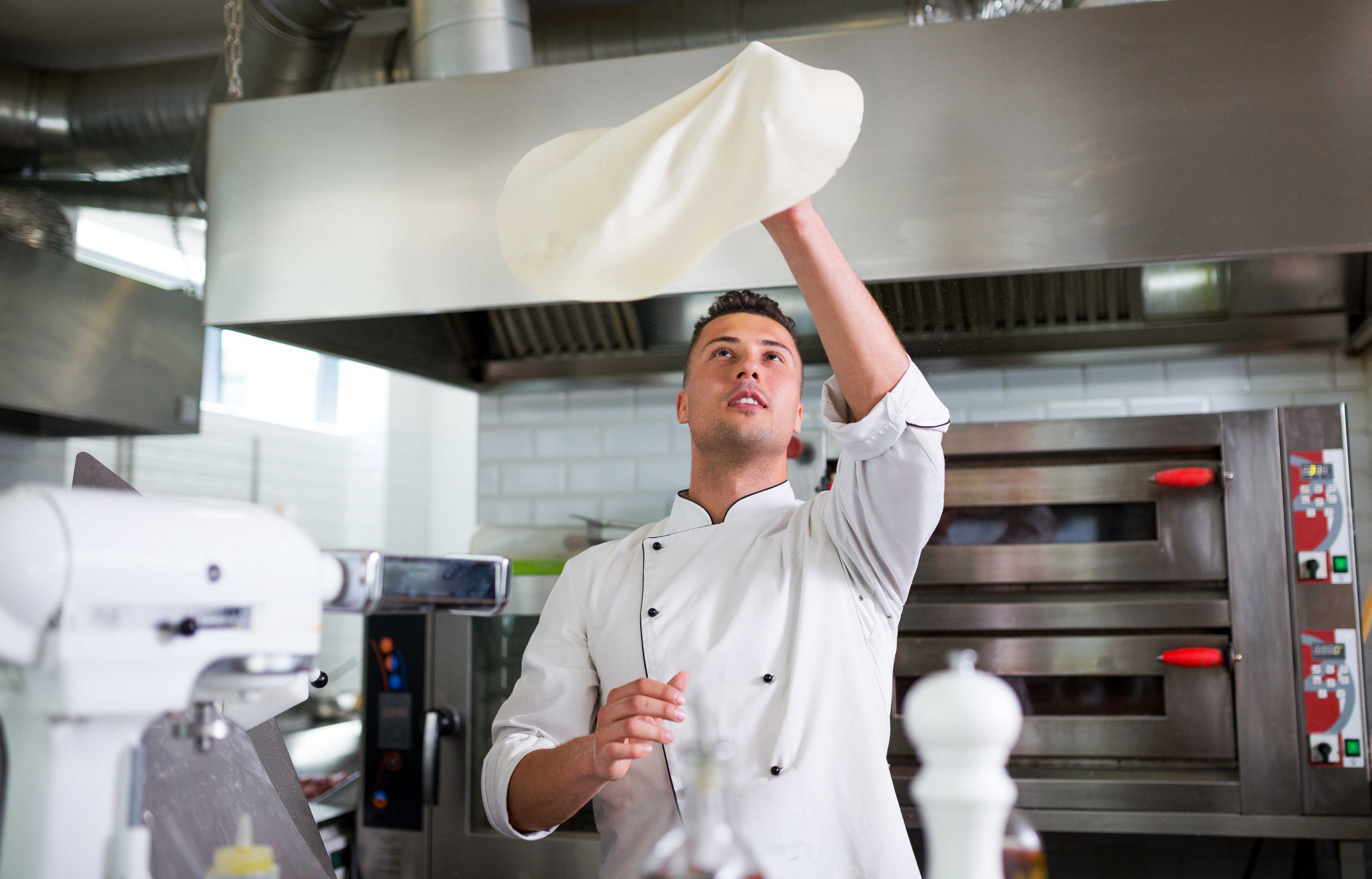 A chef is cooking in his kitchen, using mozzarella