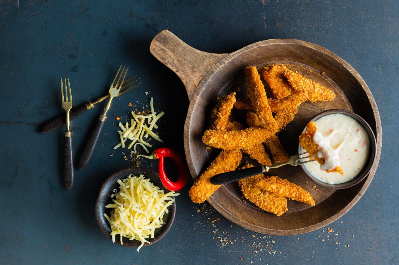 A chef is cooking in his kitchen, using mozzarella